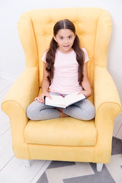 Small girl child with perfect hair. International childrens day. Happy little girl. Beauty and fashion. small kid fashion. Childhood happiness. I love my job. She has got the book she needs.