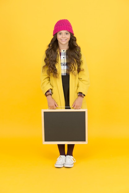 Small girl enjoy autumn stylish schoolgirl blackboard copy space for ad space for creativity back to school desire for study smiling child craving for education retro and modern school