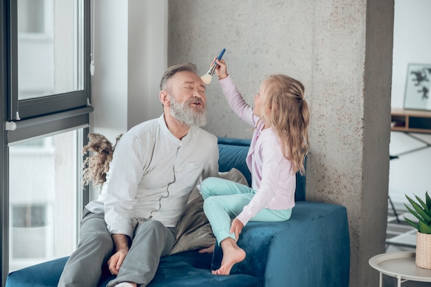 A small girl and her father playing together