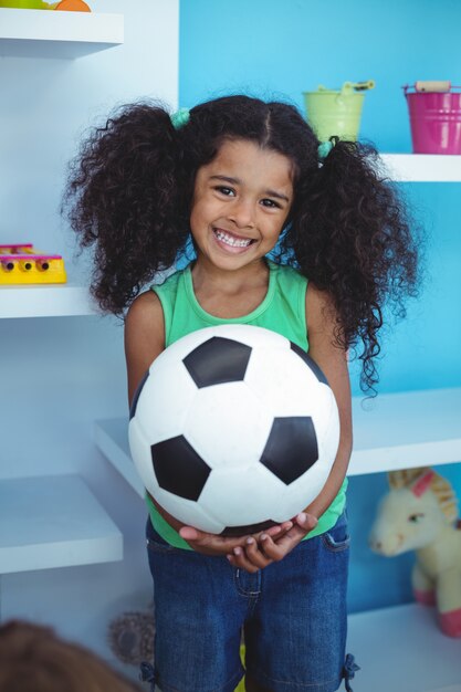 Small girl holding a soccer ball