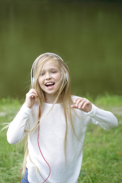 Small girl in music hearphone