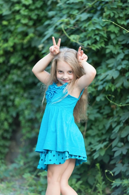 Little pretty girl poses near big tree in summer park, shallow d Stock  Photo by ©singulyarra1 137047974