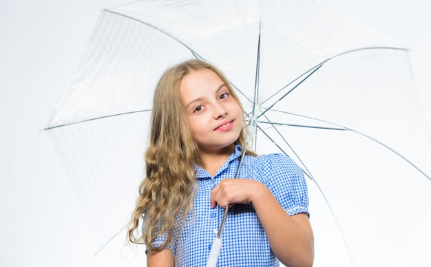 Small girl with umbrella in rainy weather. Happy little girl with umbrella. Happy childhood. School time. Autumn fashion. Child. Feeling protected at this autumn day.