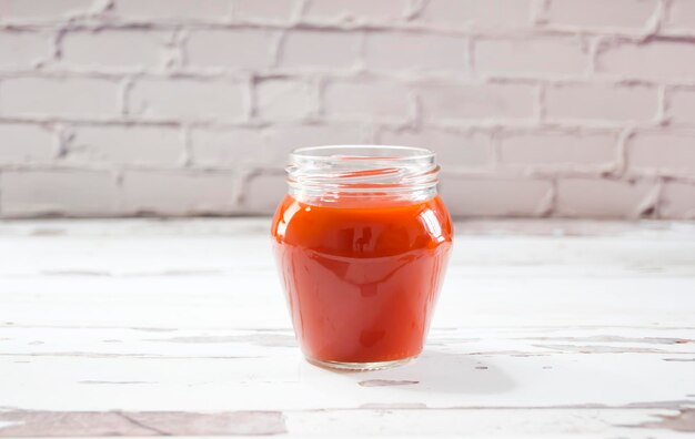 Small glass jar filled with homemade tomato sauce