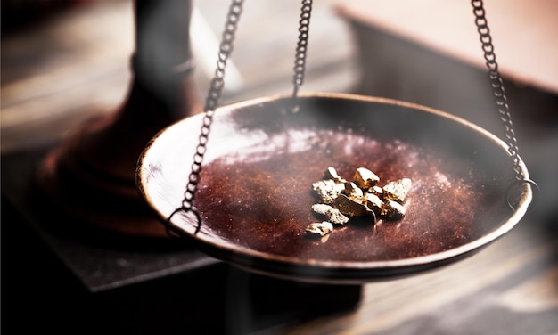 Small gold nuggets in an antique measuring