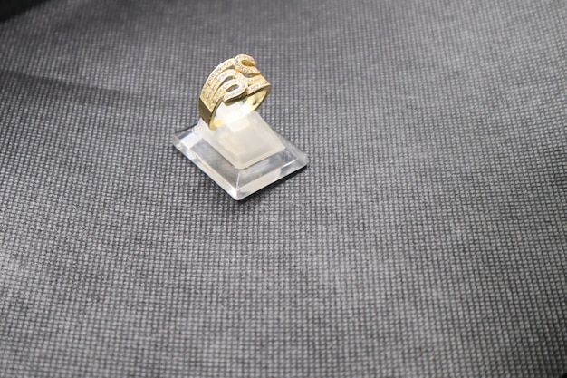 a small gold object with a face on it