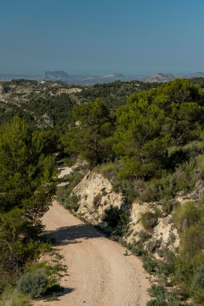 Small gravel mountain road passing over a mountain range Costa Blanca Alicante Spain