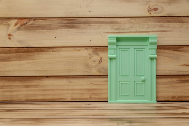 Small green door on a wooden wall