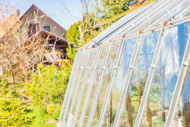 Small greenhouse in rural area. Small village glasshouse for food.