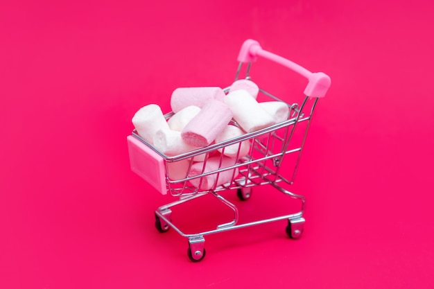 Small grocery cart full of sweet marshmallow candies. Give gifts with love on Valentine's Day