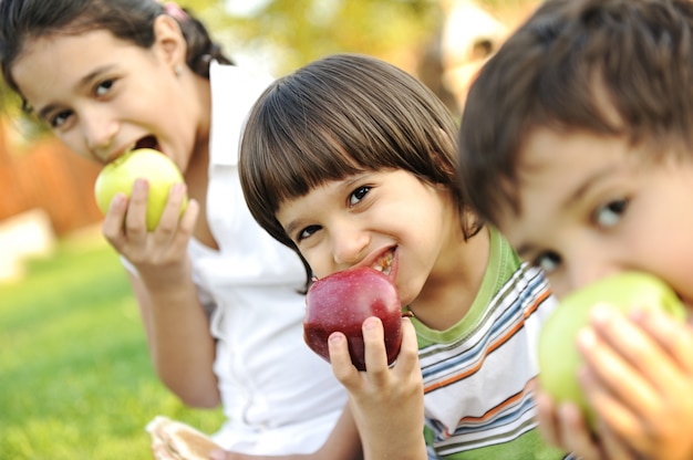 Small group of children eating apples together