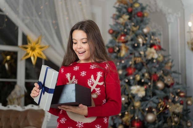 Small happy girl at christmas. Happy new year. The morning before Xmas. New year holiday. Christmas. Kid enjoy the holiday. little child girl likes xmas present. Celebrating New Year together.