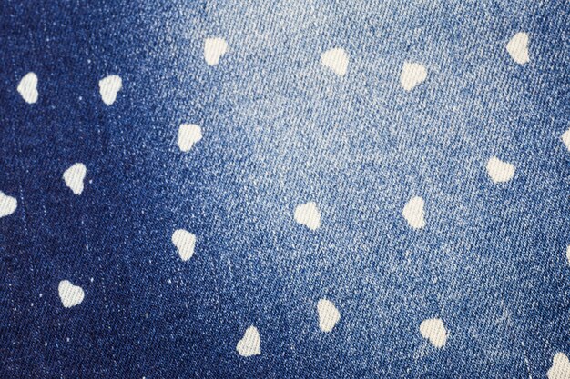 Small heart blue jeans texture background.