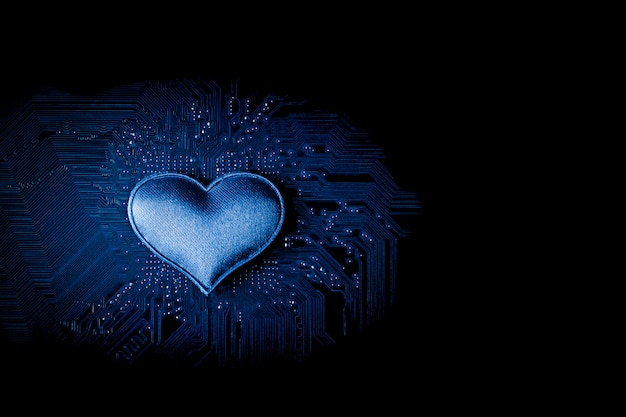 Small heart at computer circuit board.