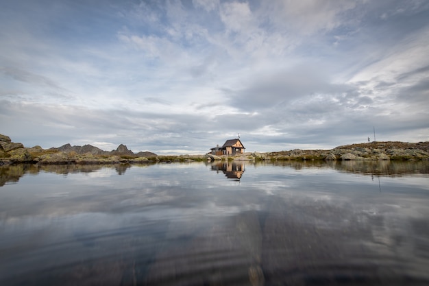 Small hermitage in the mountains near a lake