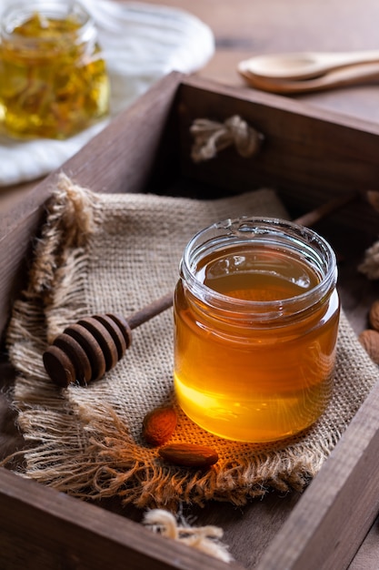 Small honey dipper with spoon in a wooden box