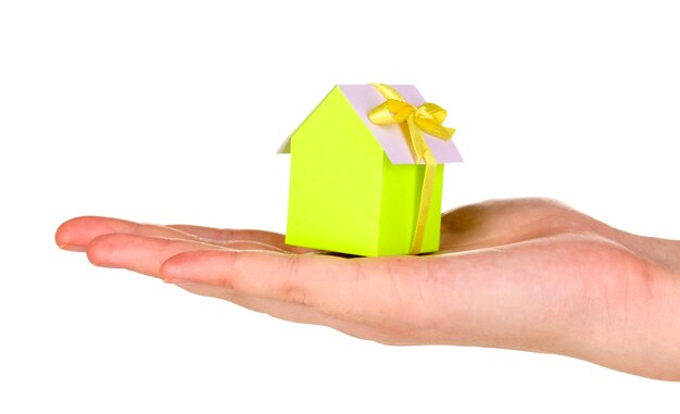 Small house in hand isolated on white