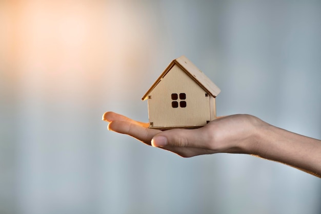 small house in the hand of a man