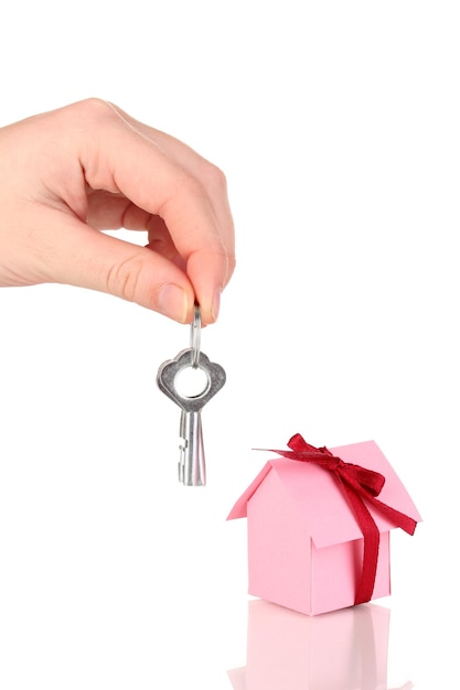 Small house with key isolated on white