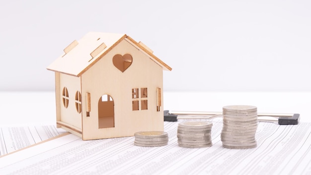 Small houses coins and office supplies on financial statements