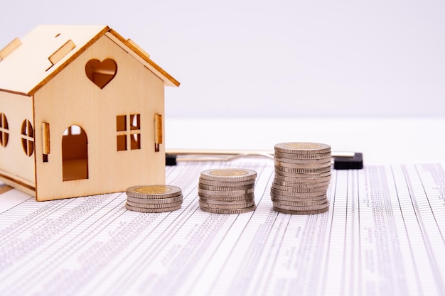 Small houses coins and office supplies on financial statements