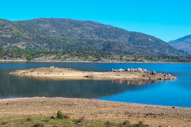 A small island in the middle of a lake caused by the lowering of the water level