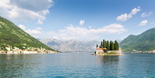 Small island in the sea between mountains