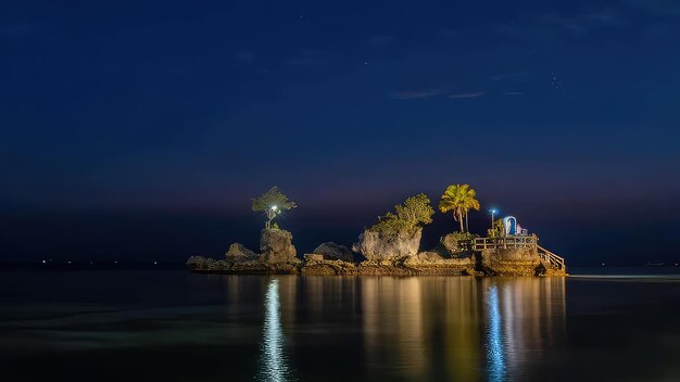 Photo a small island with a house on it and a tree on the left side