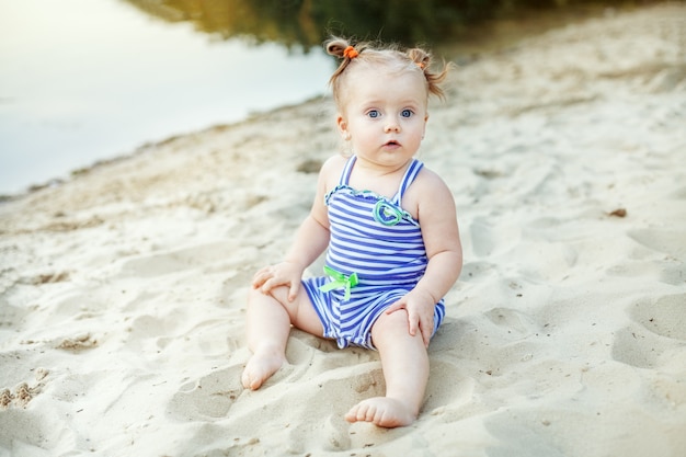 Small kid girl playing in the sand. childhood, leisure and lifestyle.