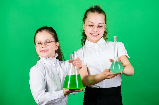 Small kid study. Chemistry lesson. Having fun with chemistry. Educative experiment. Chemistry fun. Knowledge day. Schoolgirl with colorful chemical liquids. Education concept. Safety measures.