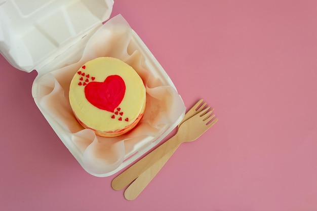 A small Korean-style bento cake in a box for one person. Cute dessert gift for birthday and valentine's day. Selective focus.