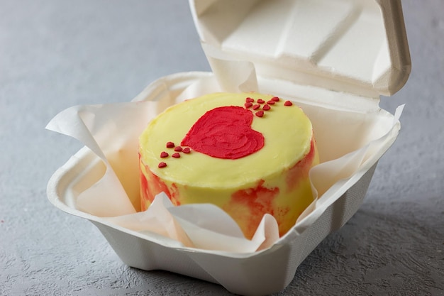 A small Korean-style bento cake in a box for one person. Cute dessert gift for birthday and valentine's day. Selective focus.