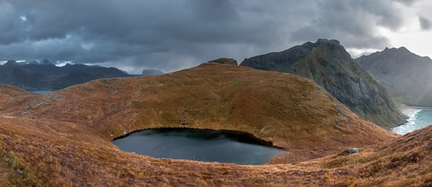 Small lake among the Mountains on the beach of Kvalvika view from Mount Ryten in fall time