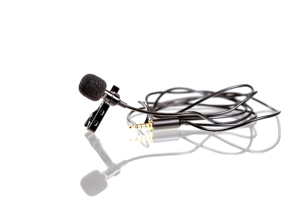 Photo small lavalier microphone or lapel mic with clip. professional sound recording equipment for cell phone.