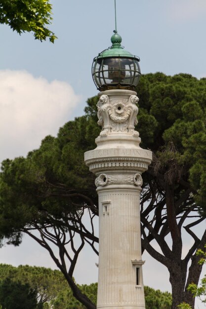 Small lighthouse between the trees in rome italy