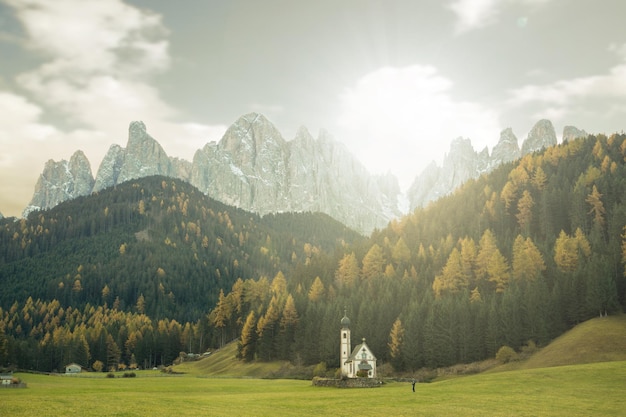 Small lovely church near Dolomite mountian with natural Autumn season.