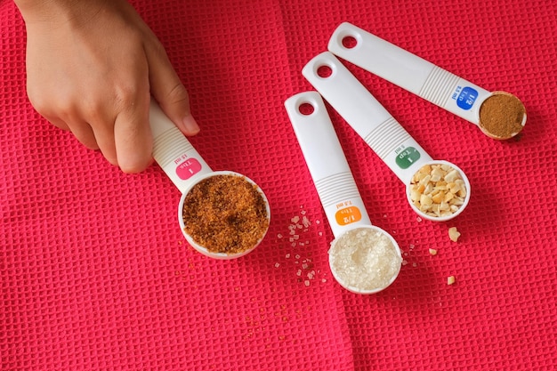 Small measurement scoops with various ingredients on red napkin