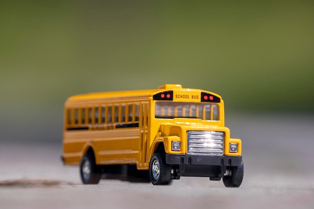 Small model of american yellow school bus as symbol of education in the USA