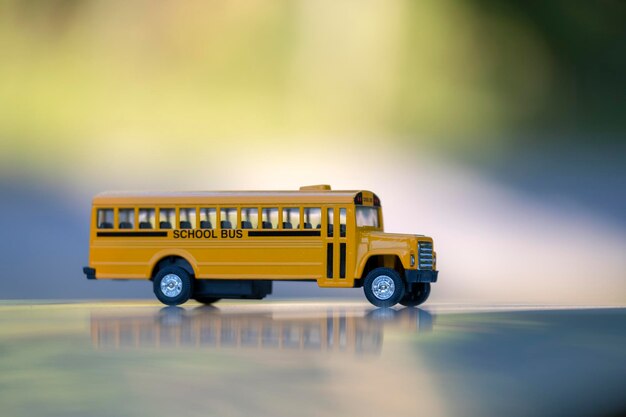 Small model of american yellow school bus as symbol of education in the USA