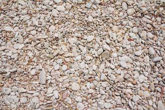 Small naturally polished rock pebbles background. 