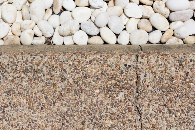 Small naturally polished white rock pebbles mineral stones background