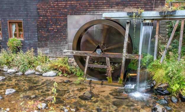 Small noria hydropowered scoop wheel in rural of Germany