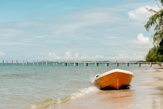 Small orange boat on the beach