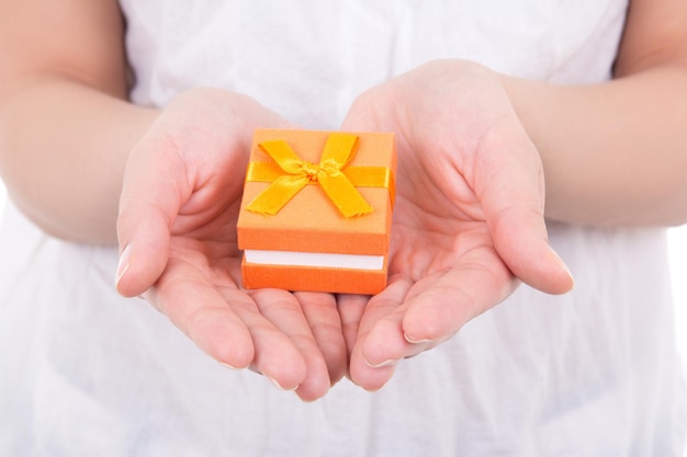 Small orange gift box in woman hands