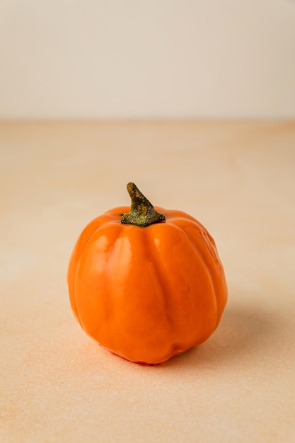 Small orange mousse cake in the form of pumpkin for Halloween