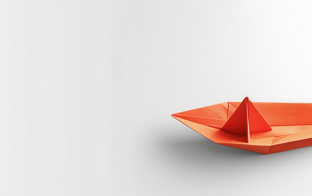 a small orange paper boat is made by a paper boat