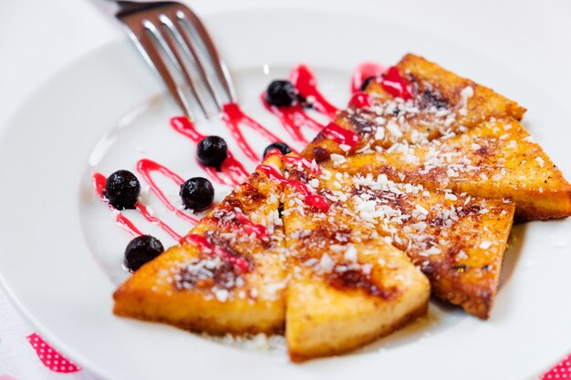 Small pancakes with raspberries and bilberries. close up