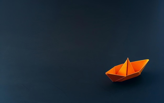 a small paper boat is on a black table