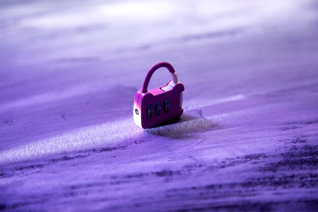 small pink lock on wooden background