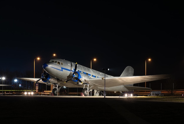 Small plane at the airport against the background of the night sky.